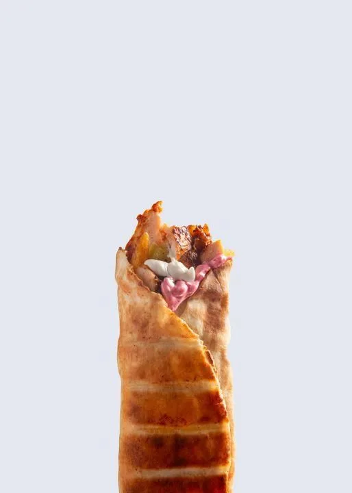 A wrap photographed for a Zayos restaurant's online menu, on a plain pale background